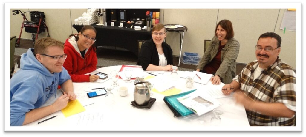 Five people sitting at a table taking part in a focus group.